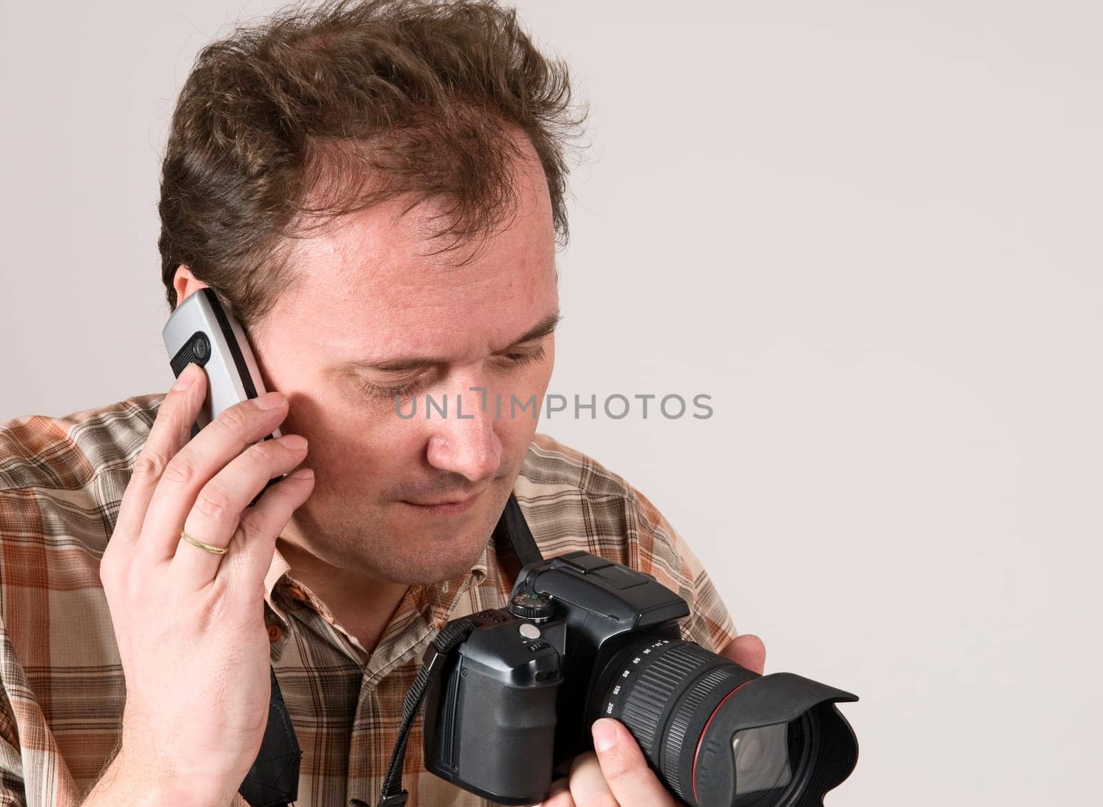 man with camera and phone