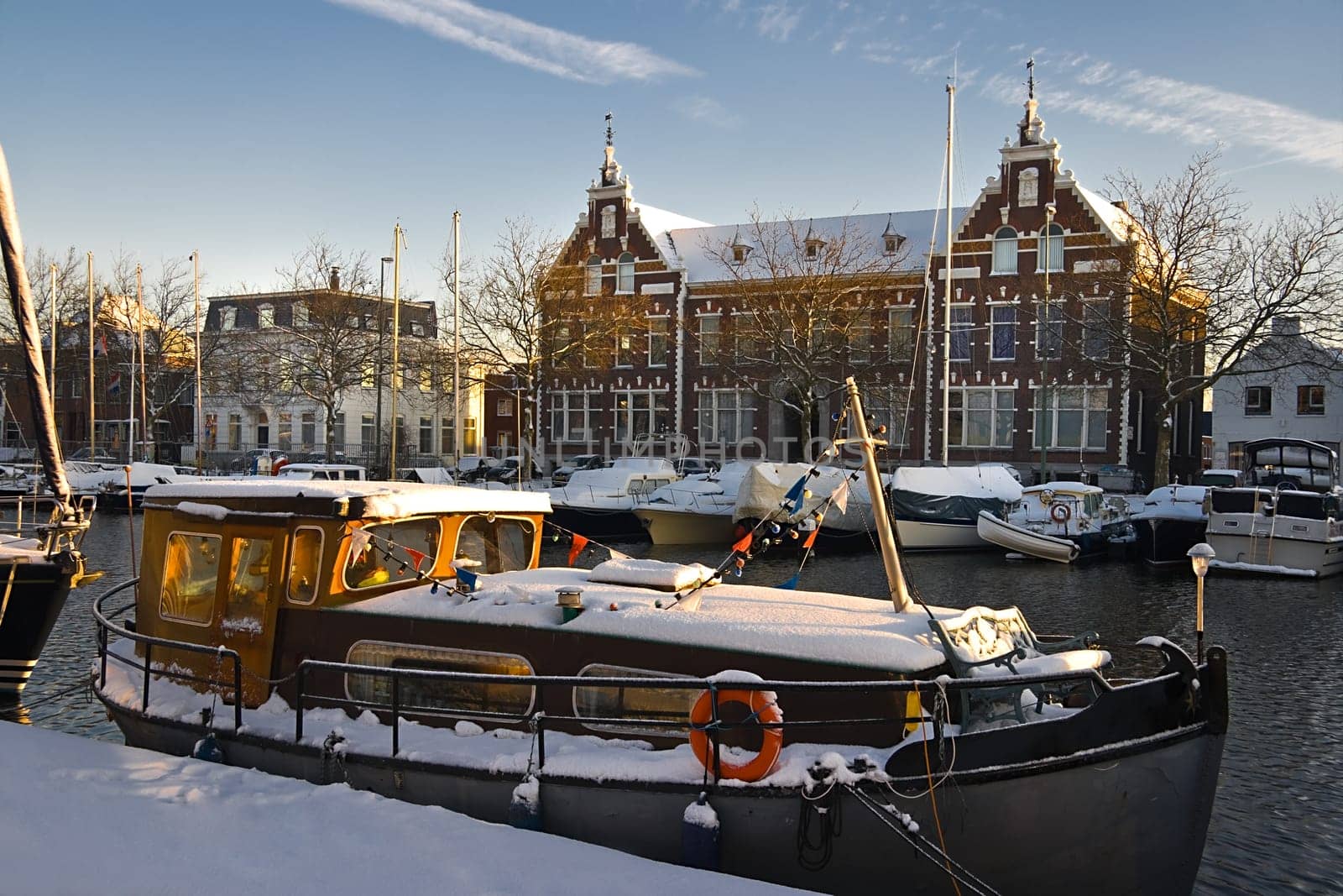 Old buildings and old ship with snow on sunny winterday