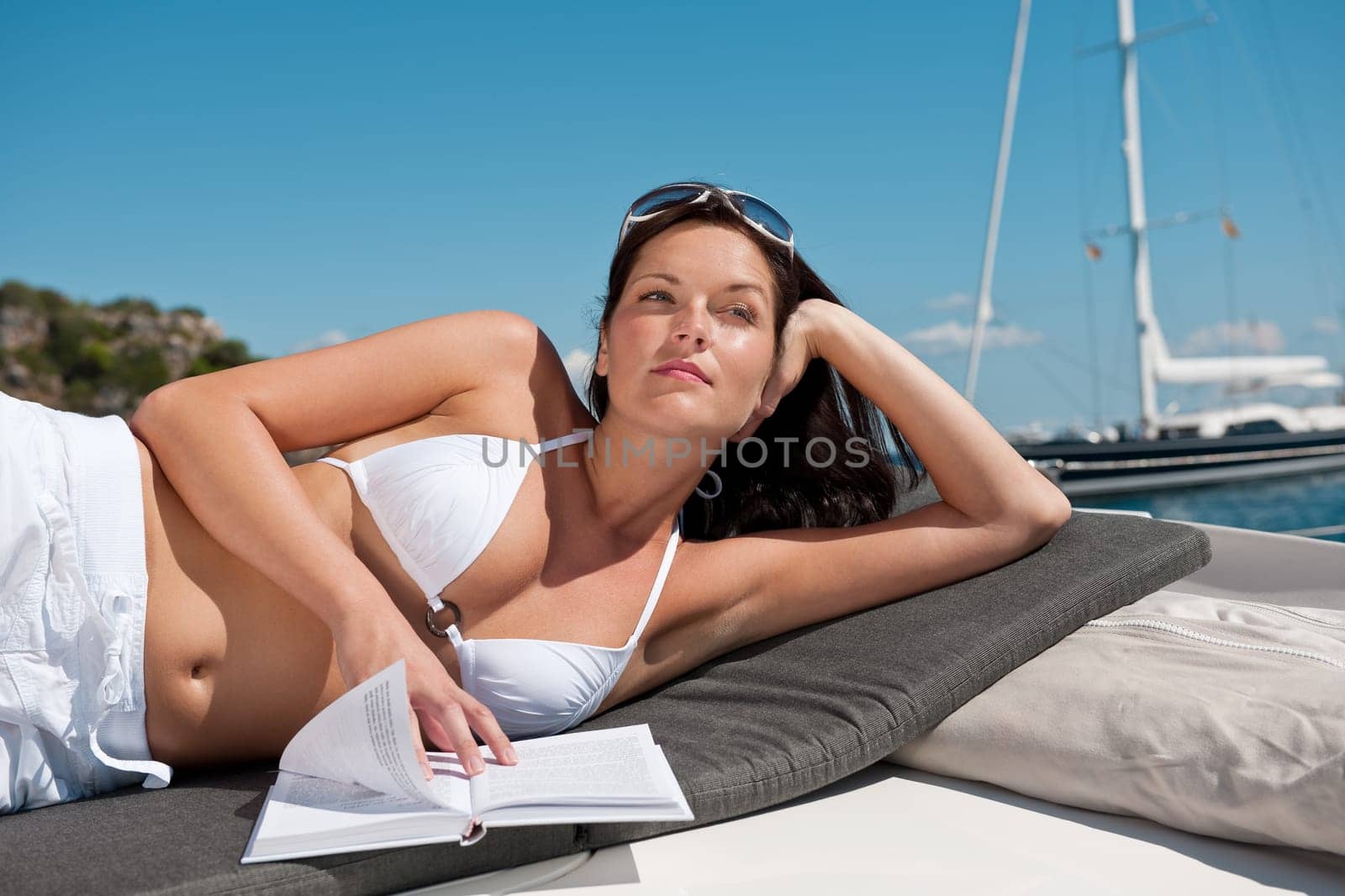 Young woman relaxing on yacht