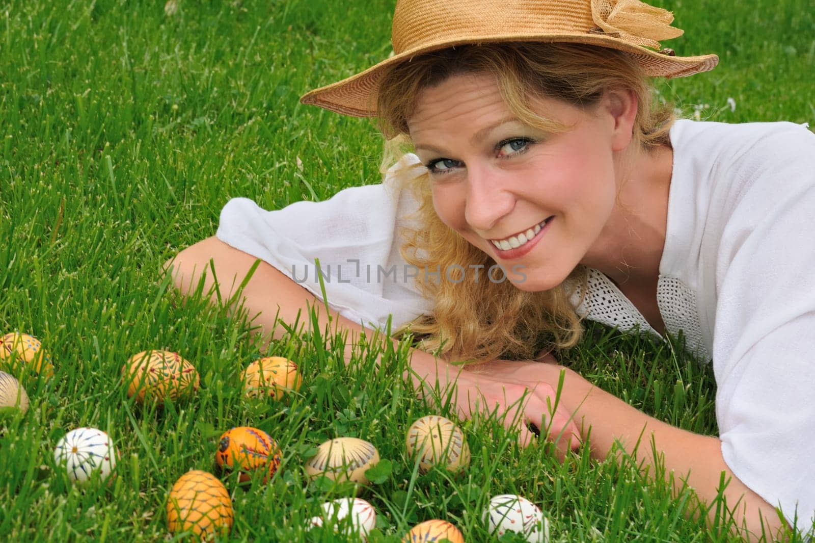 Young woman and easter eggs on grass - Easter time
