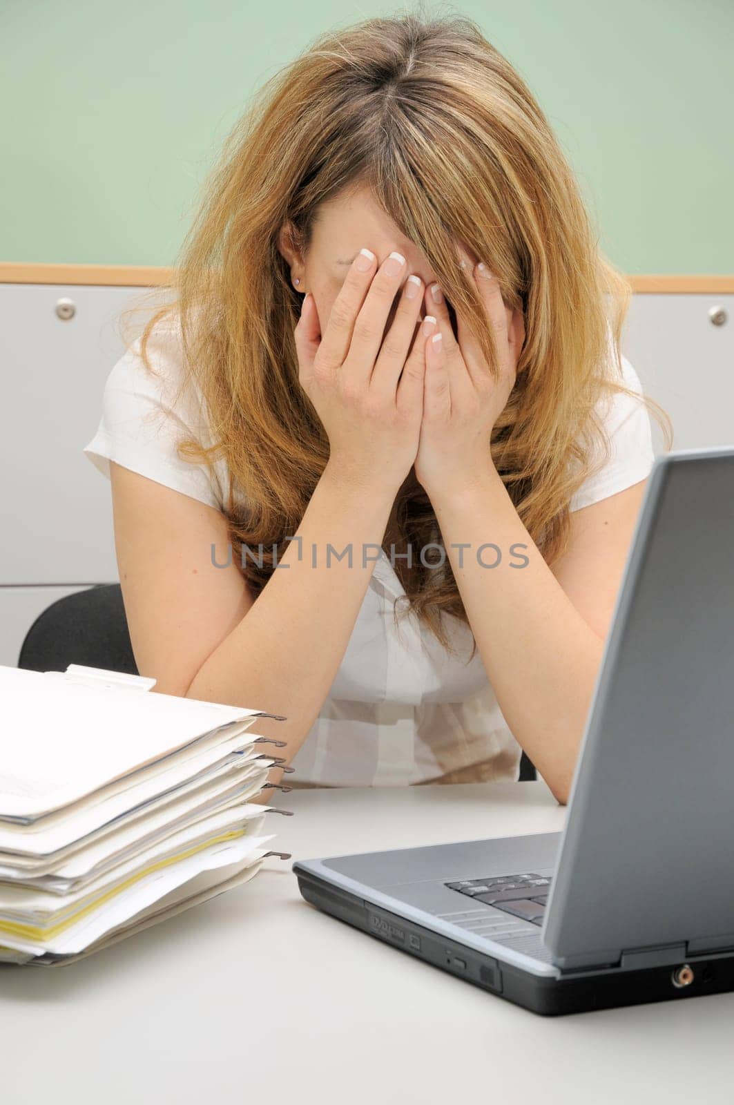 Young woman in office,frustrated
