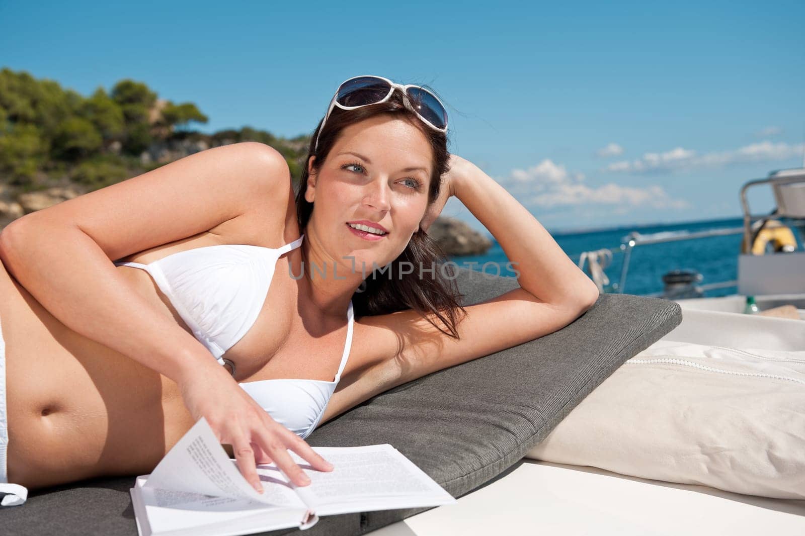 Young woman relaxing on yacht