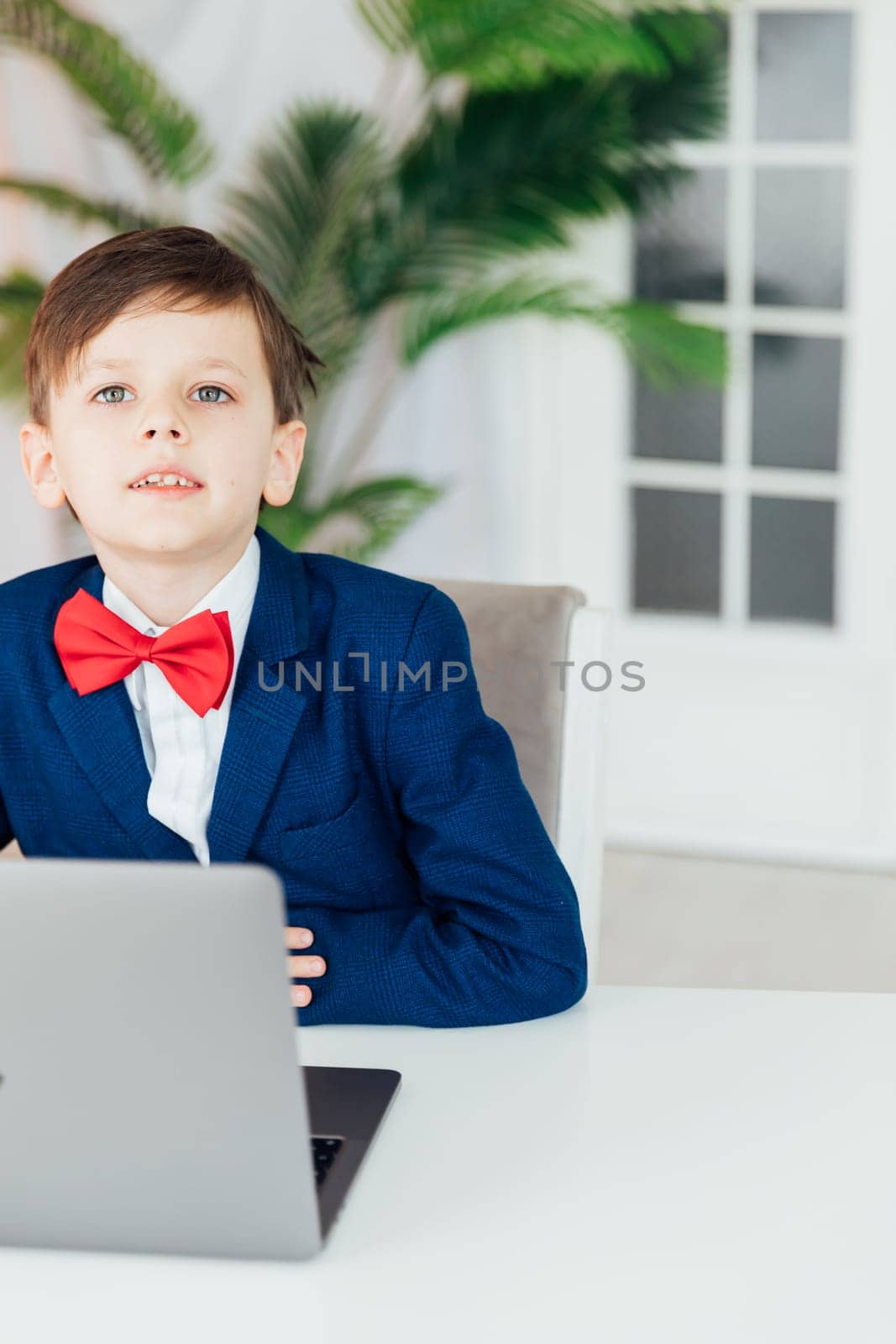 student sits at a laptop at a school education IT knowledge computer class