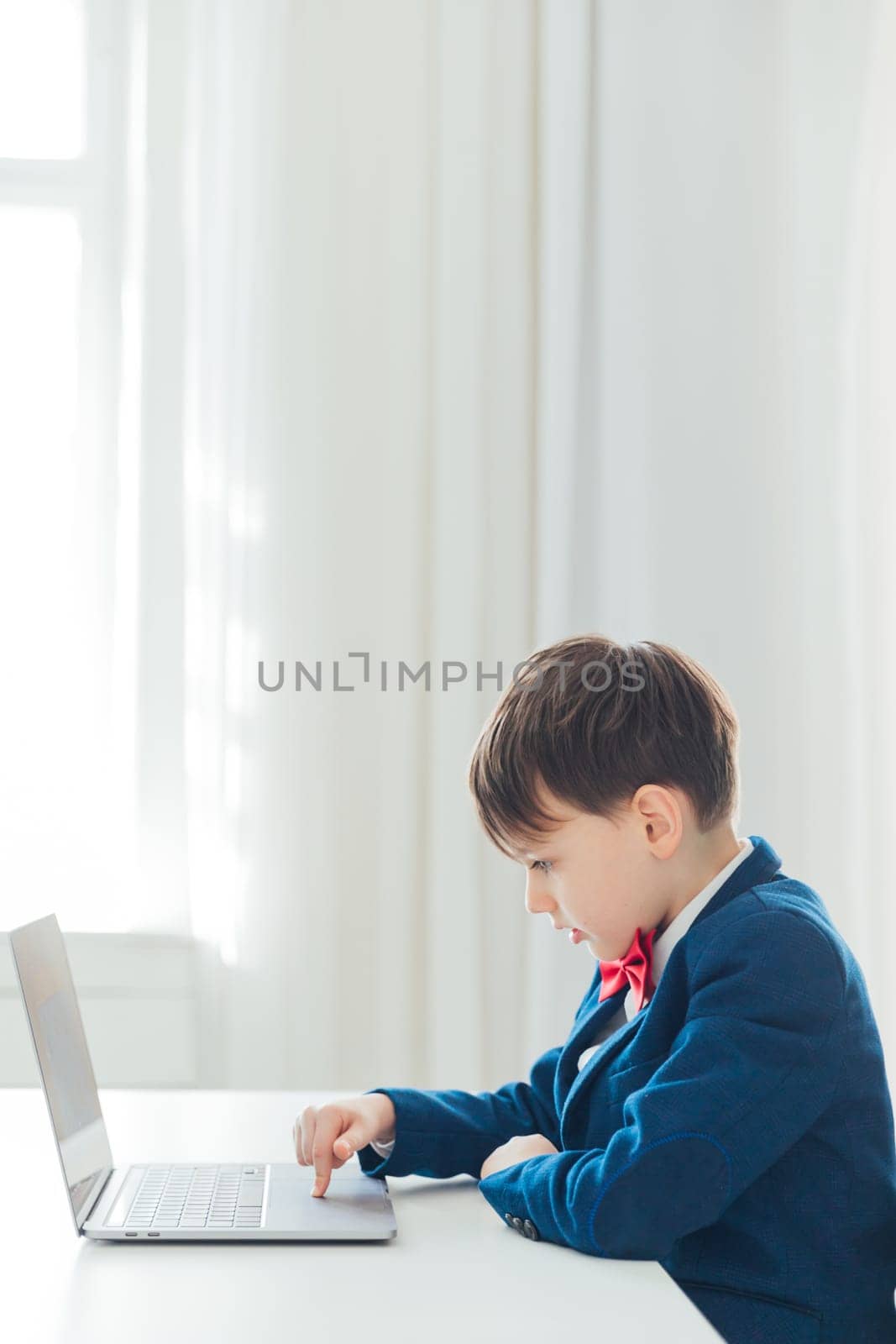 child sits at a laptop at a school education IT knowledge