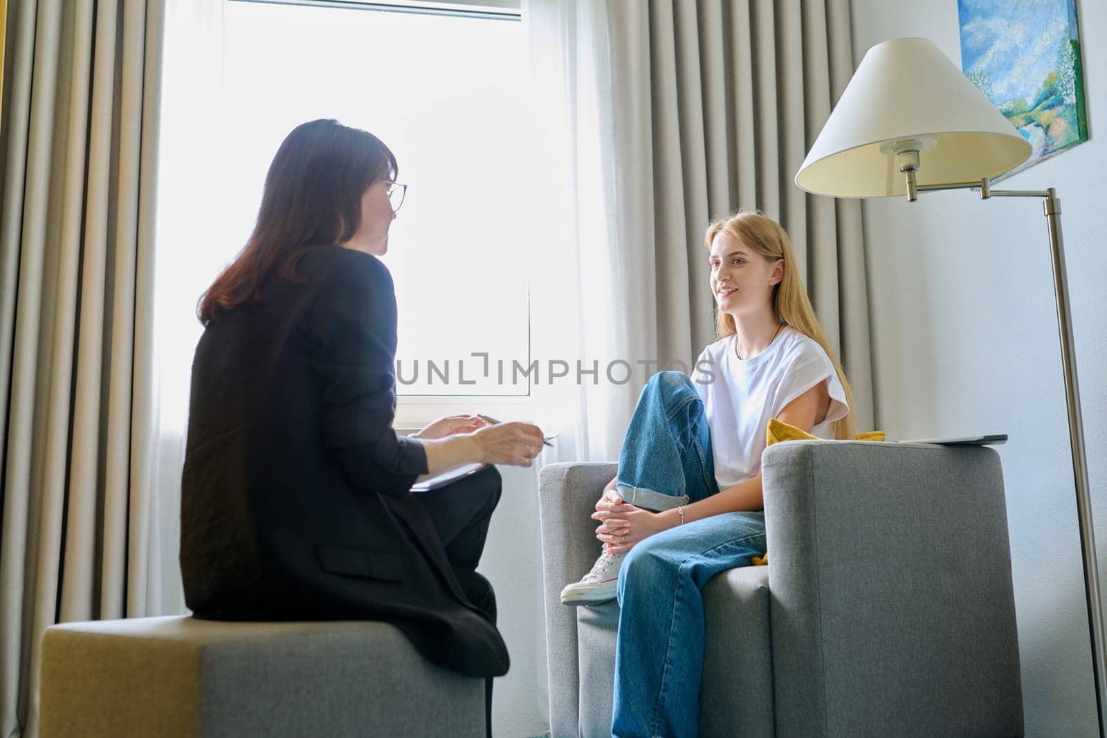 Female psychologist working with young teen girl by VH-studio