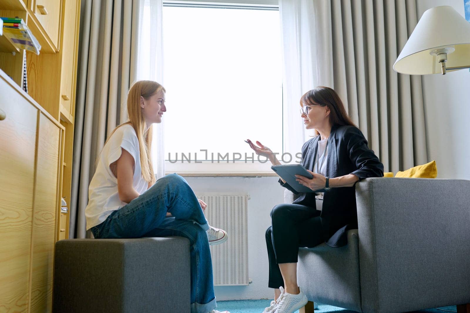 Young female at therapy meeting with psychotherapist by VH-studio