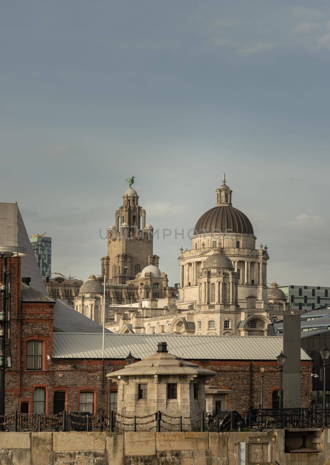 Liverpool, UK - Oct 07, 2023 - View of buildings on Liverpool's waterfront. One of the buildings which make the 'Three Graces' the other two, the Cunard building - the Royal Liver building. See through Royal Albert Dock Liverpool. Space for text, Selective focus.