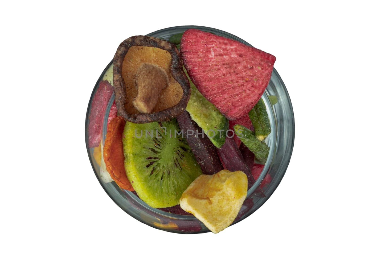 Crispy mixed veggies and fruits in the glass isolated on white background with clipping path. Different colorful dried fruits and vegetables, Healthy snacks food, Top view, Selective focus.