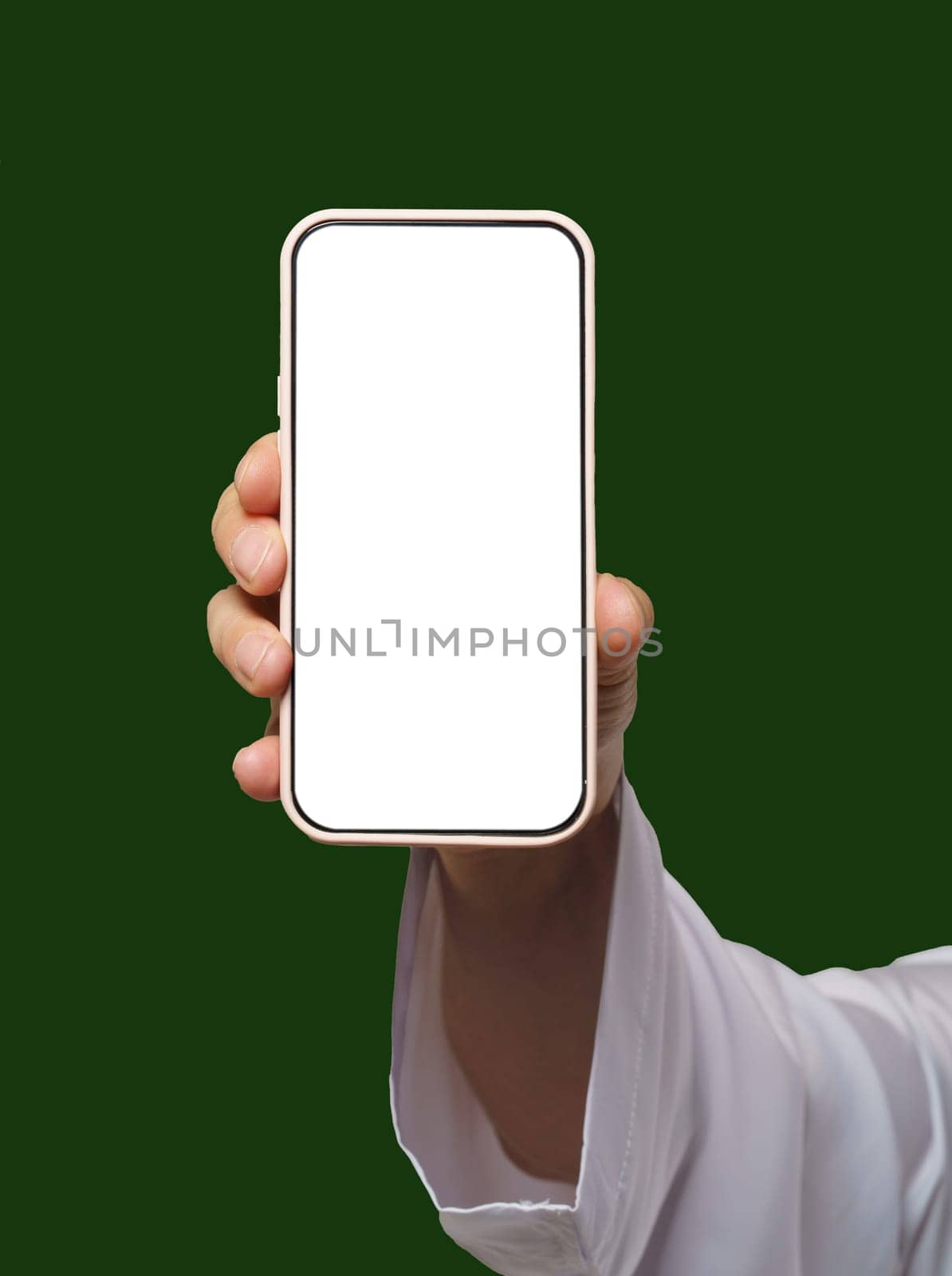 Man's hand holds smartphone with white screen on Islamic or Muslim green. Blank screen with space for copy or promotional content, ideal for app advertising and concepts with focus on Islamic audience. by LipikStockMedia