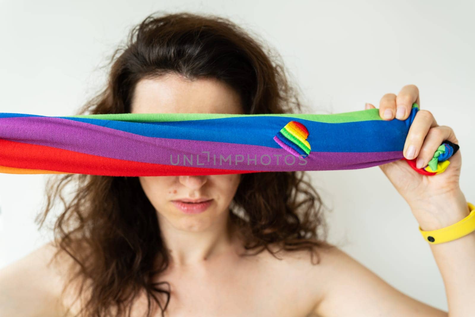 LGBT girl. The girl closes her eyes with a bright LGBT flag. There is no support from society for hiding your sexuality
