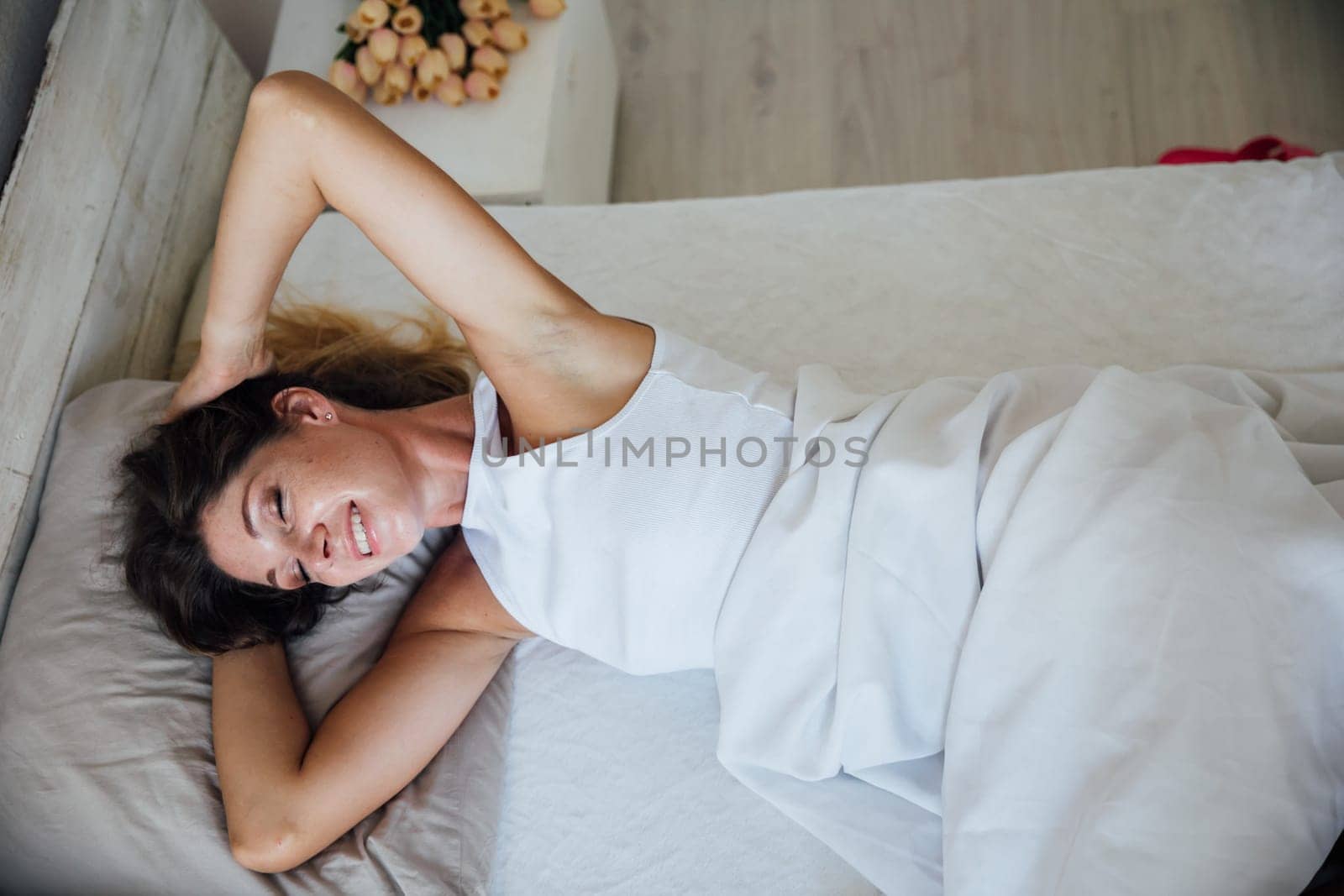 woman in her underwear in the bedroom sleeps in the morning wakes up