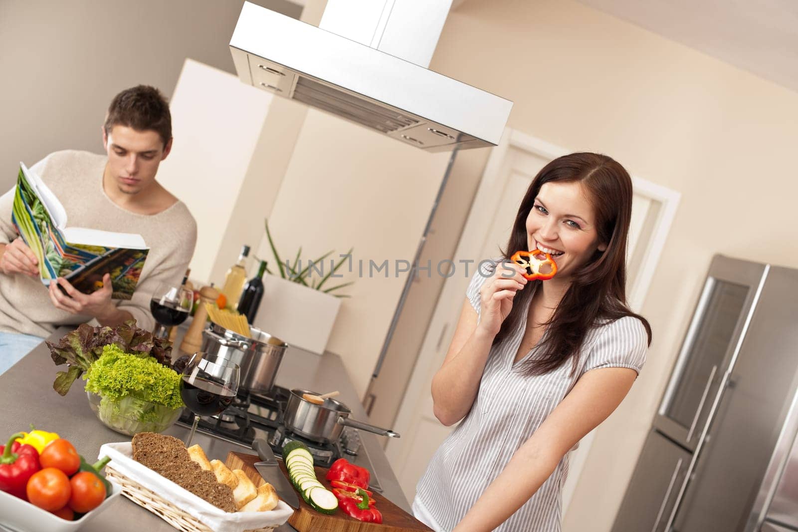 Young couple in kitchen cooking