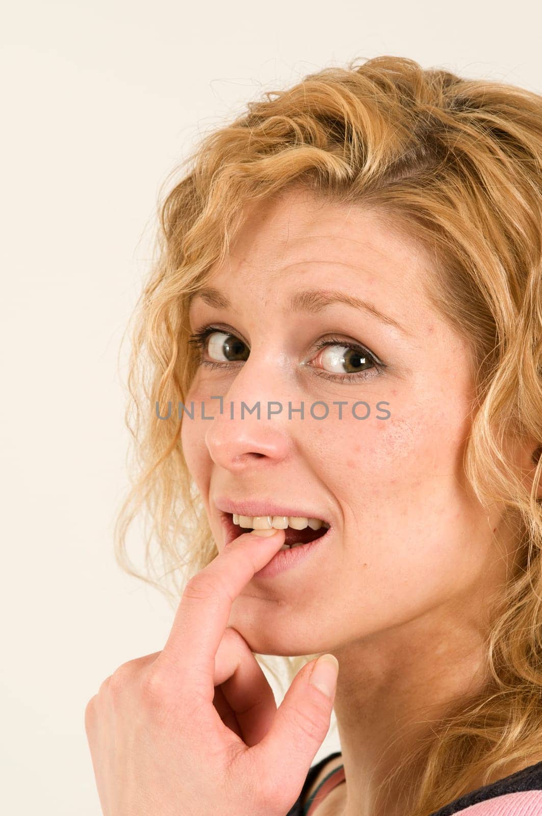 finger at the teeth