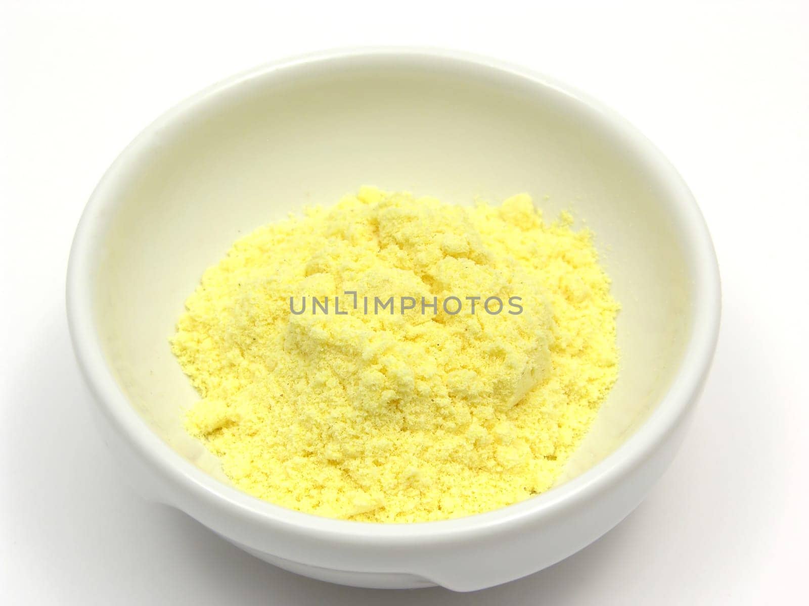 Cornmeal in a porcelain bowl on white background