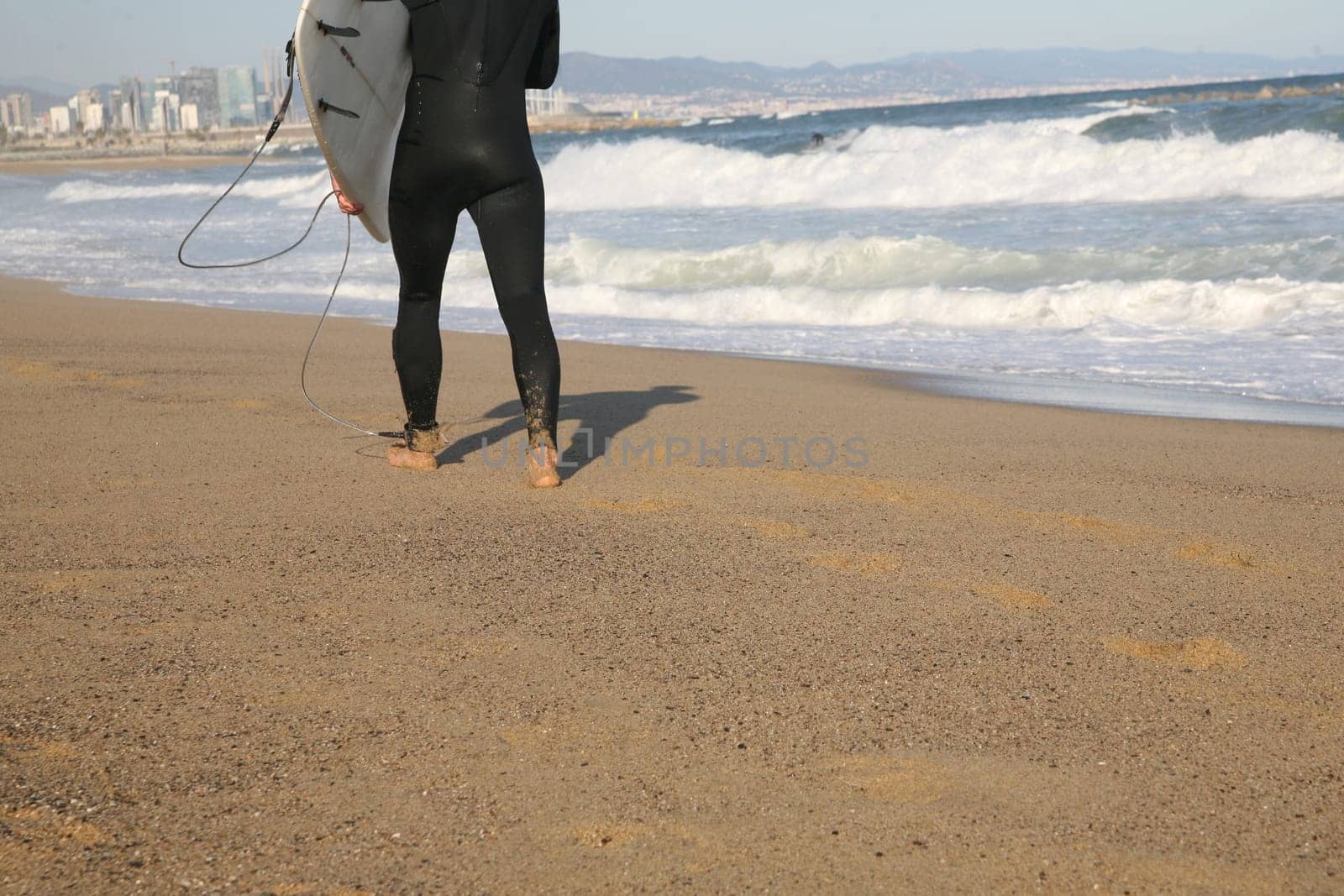 Surfer running on the beach