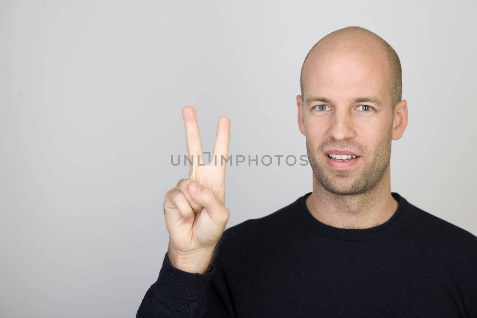 Man showing the number 2 with one finger