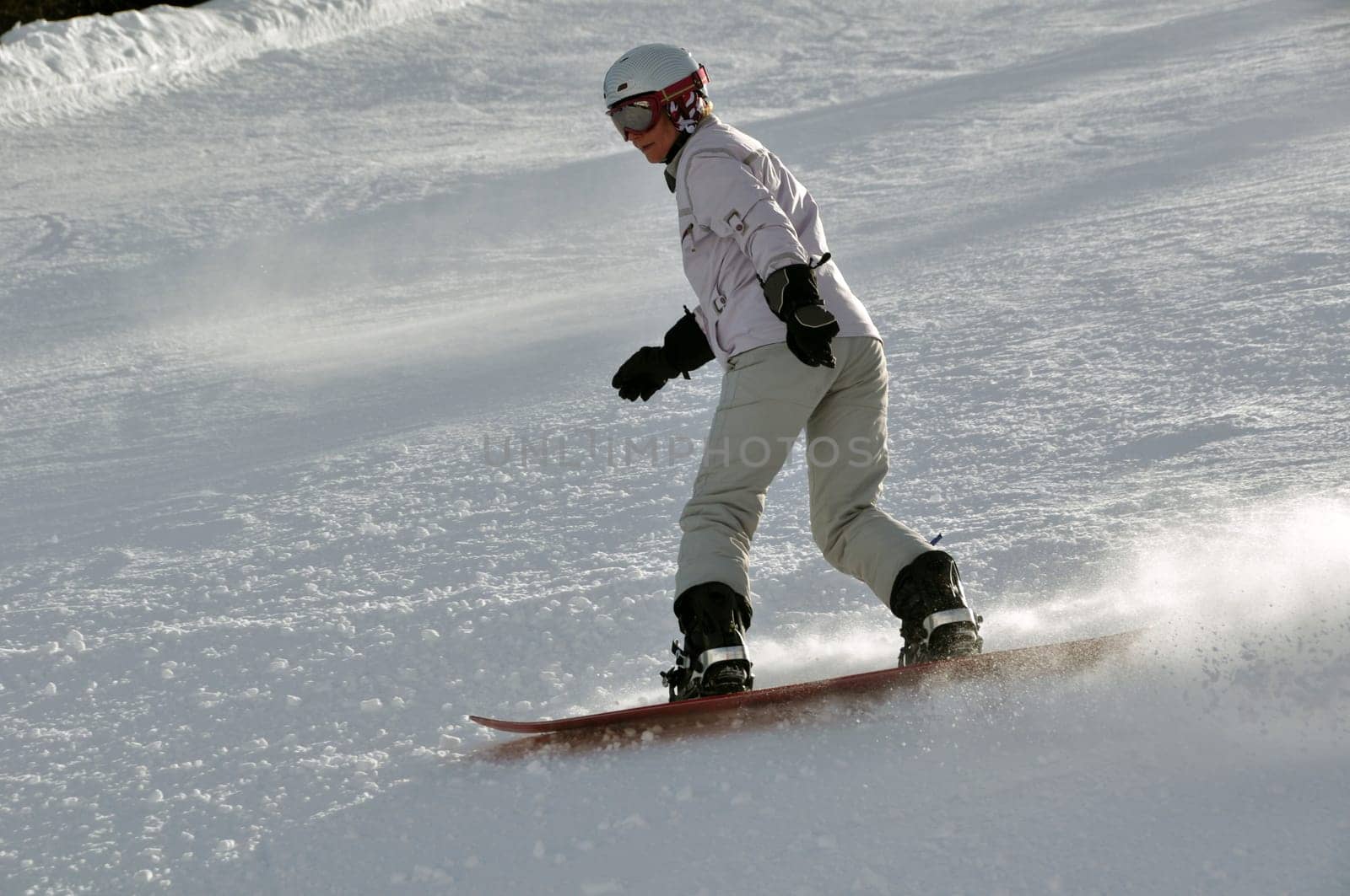 Female snowboarder in powder snow