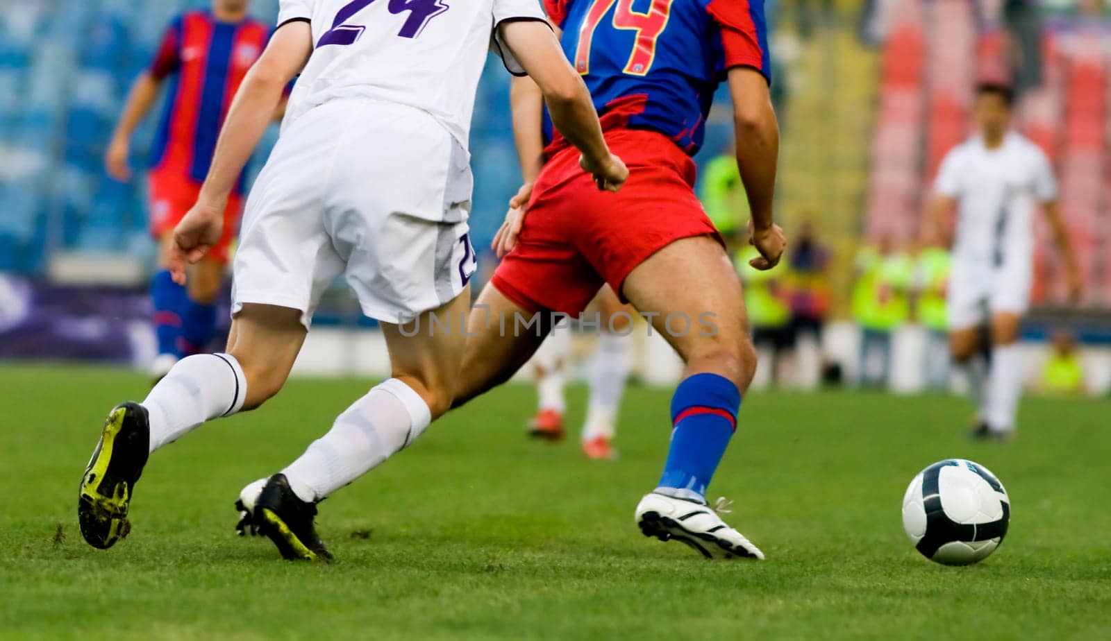 Soccer players fighting for the ball