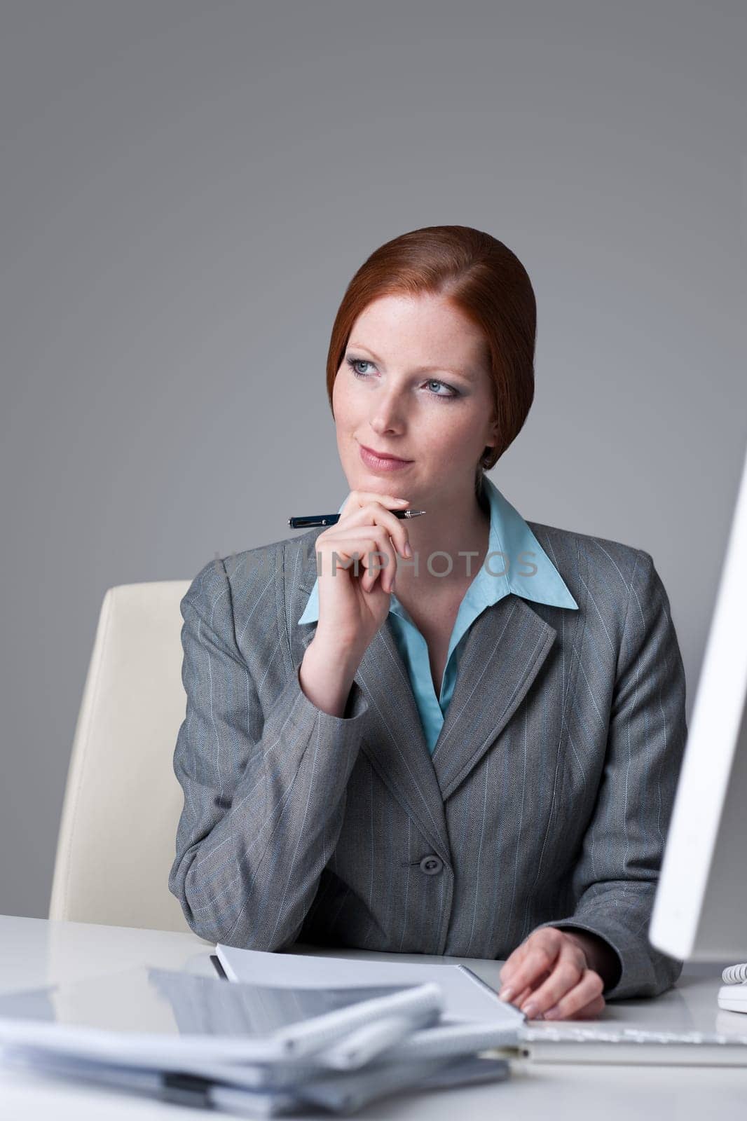 Successful business woman at office thinking