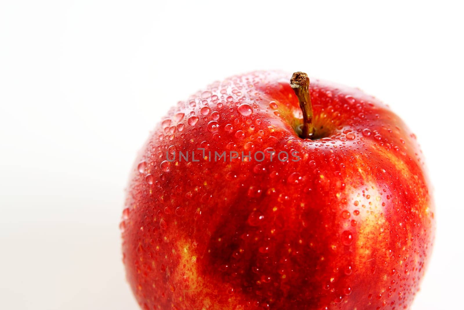 Fresh red apple with water drops