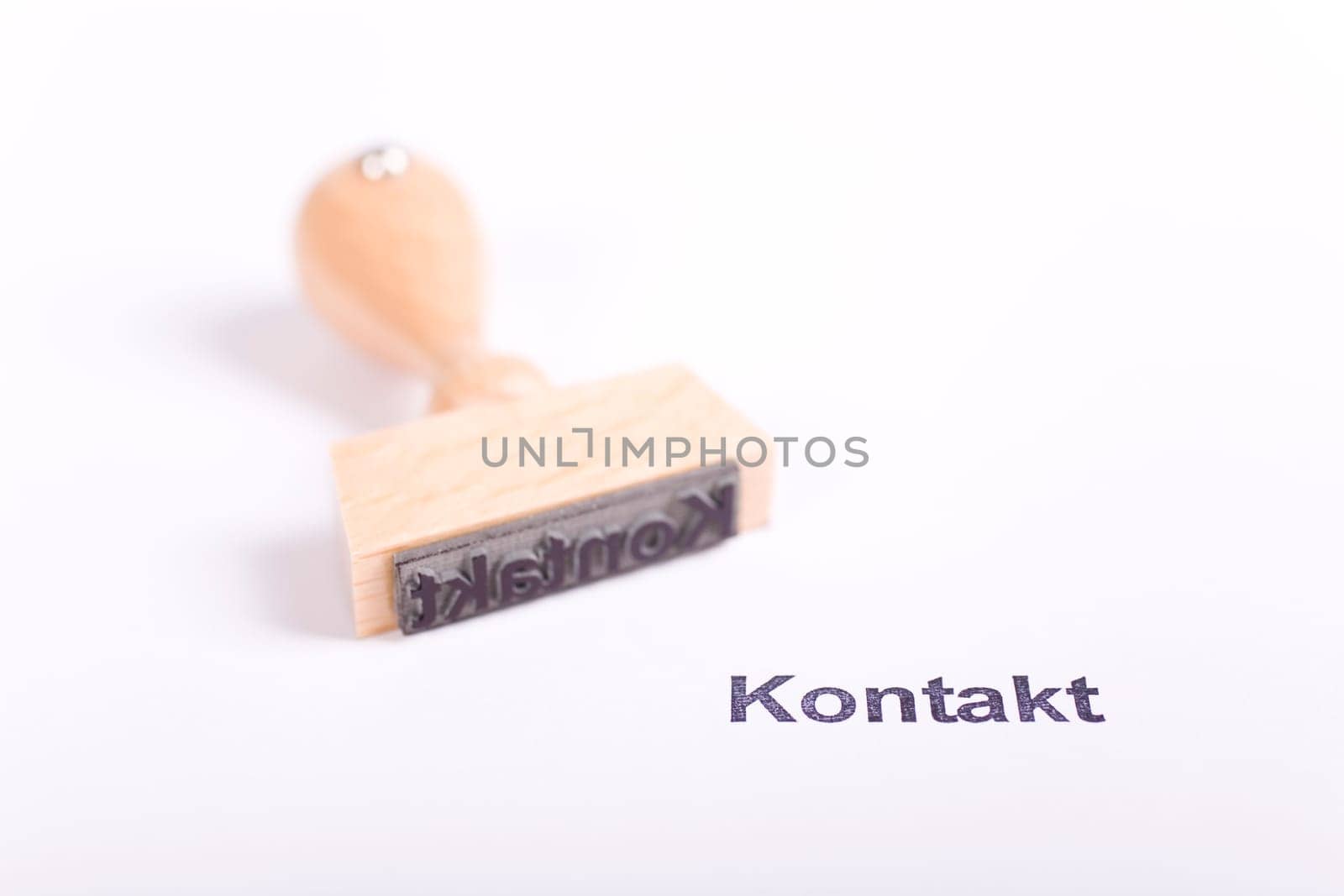 Wooden stamp with the word Contact