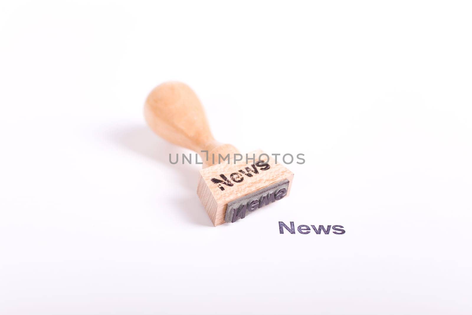 Wooden stamp with the word News