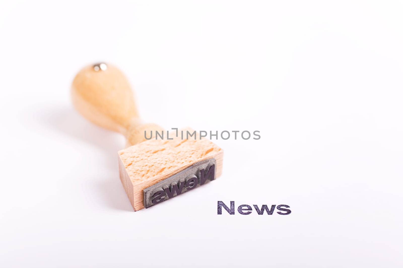Wooden stamp with the word News