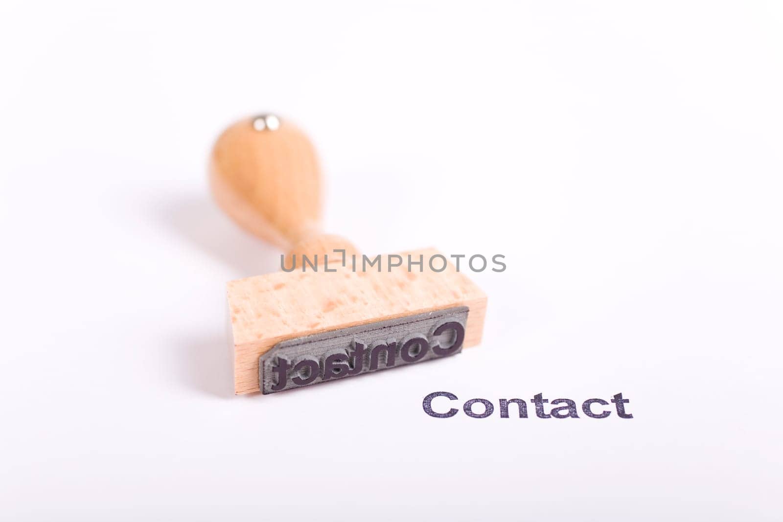 Wooden stamp with the word Contact