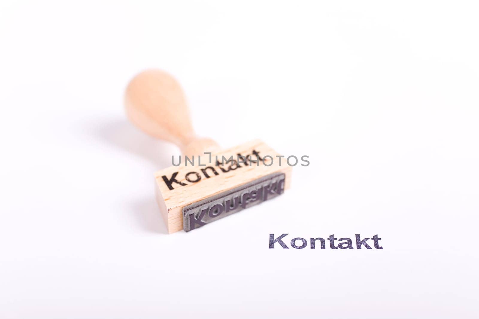 Wooden stamp with the word Contact