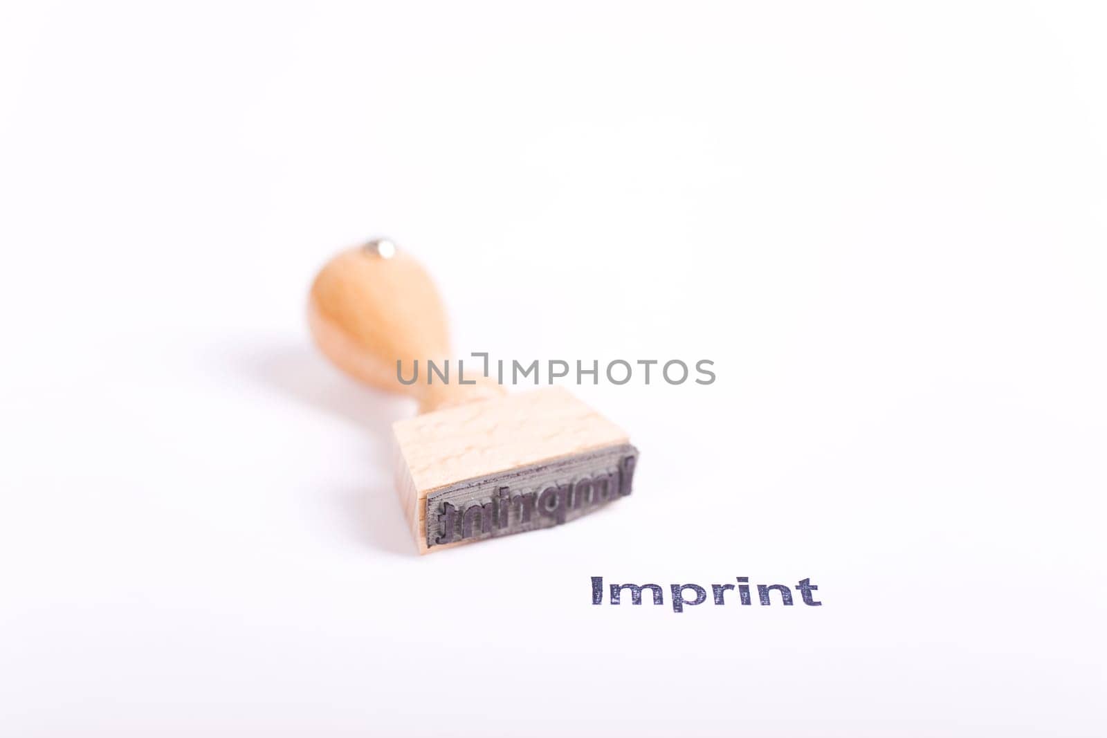 Wooden stamp with the word Imprint