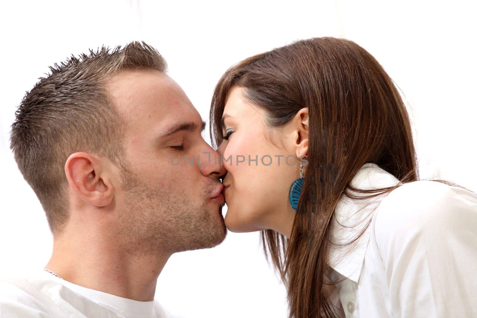 A young couple kissing.