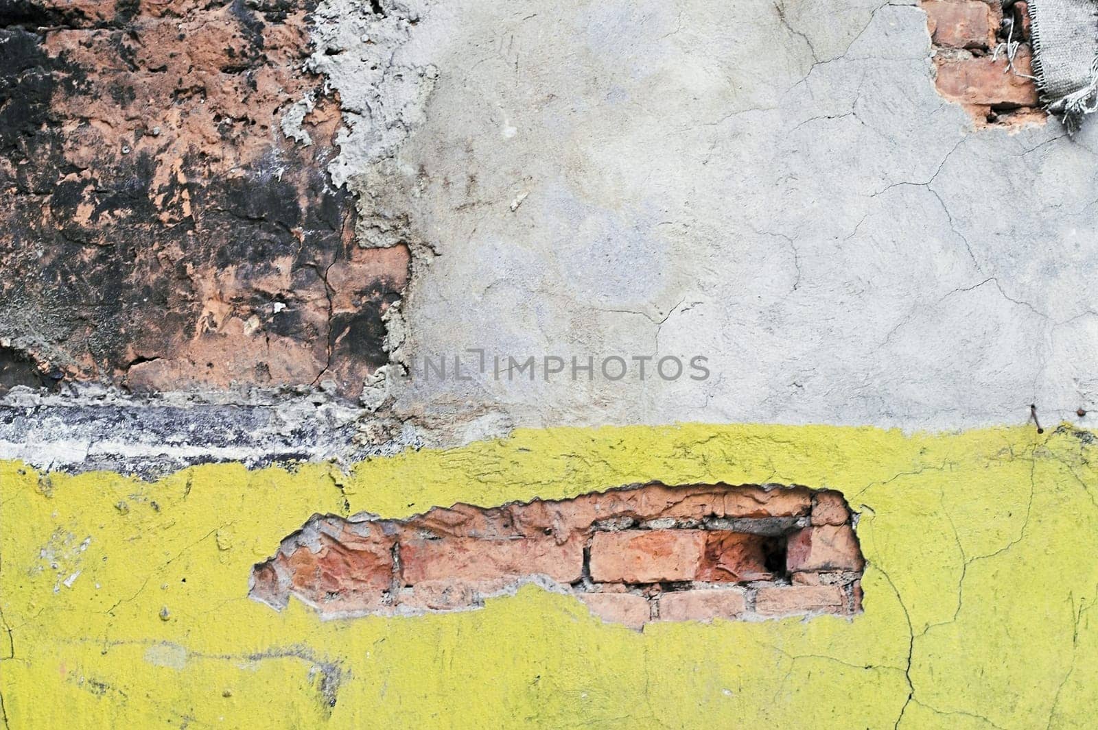 A corroded wall in a back alley.