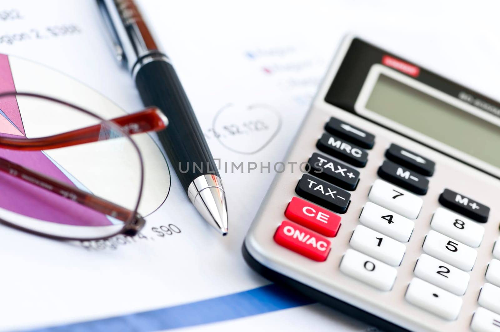 Tax calculator pen and glasses