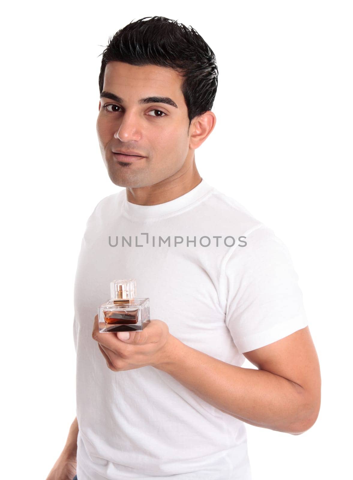 Adult male holding a bottle of aftershave or mens fragrance
