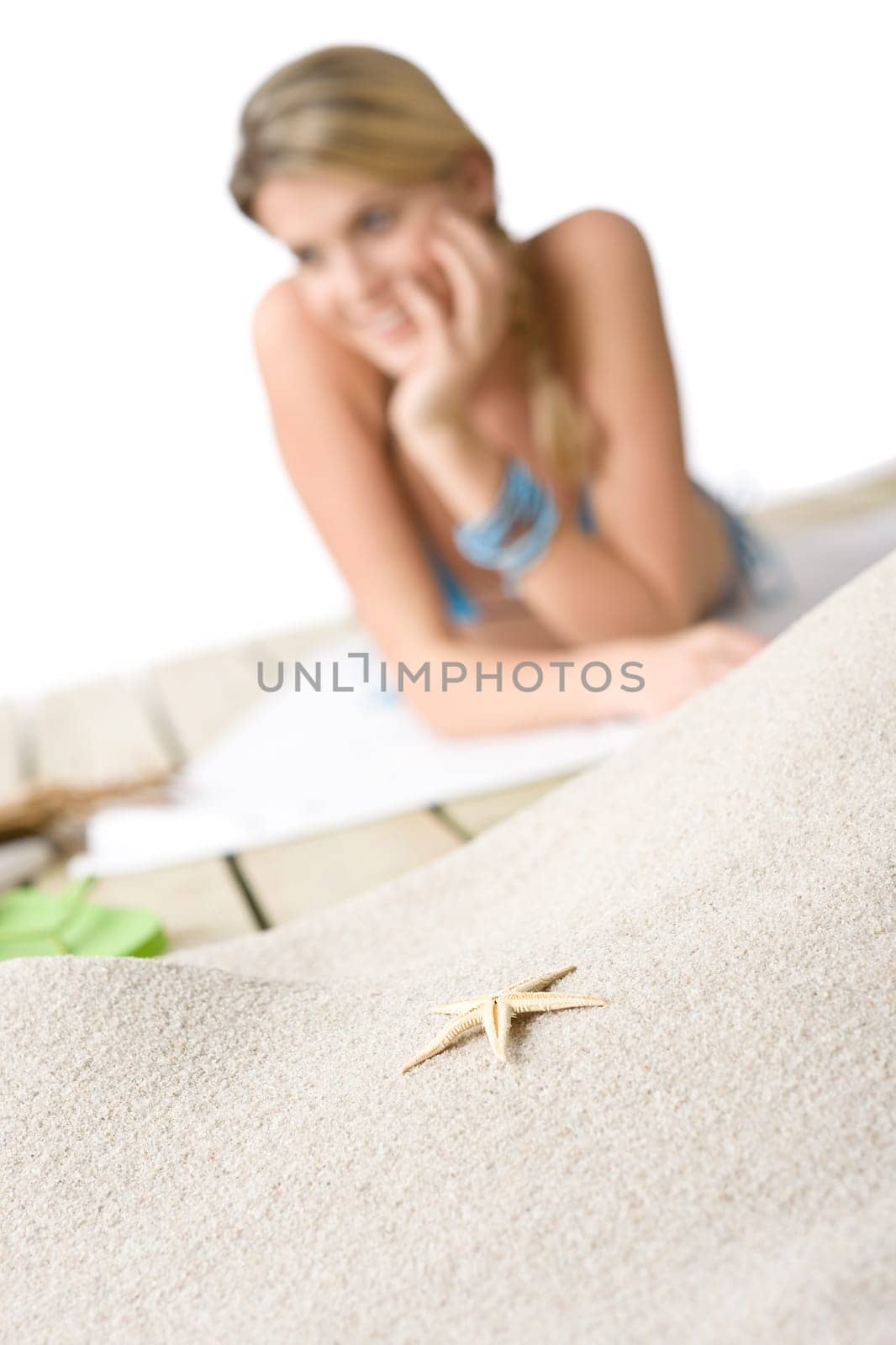 Woman on beach, Starfish on sand