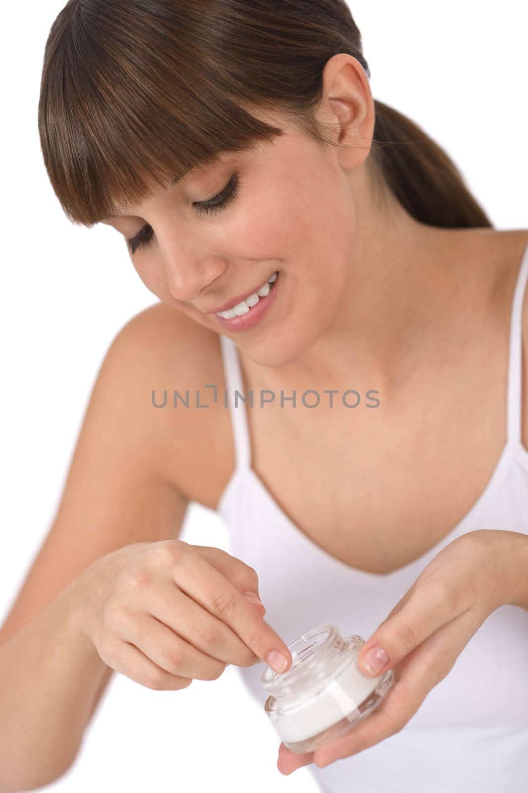 Body care - Female teenager applying moisturizer cream