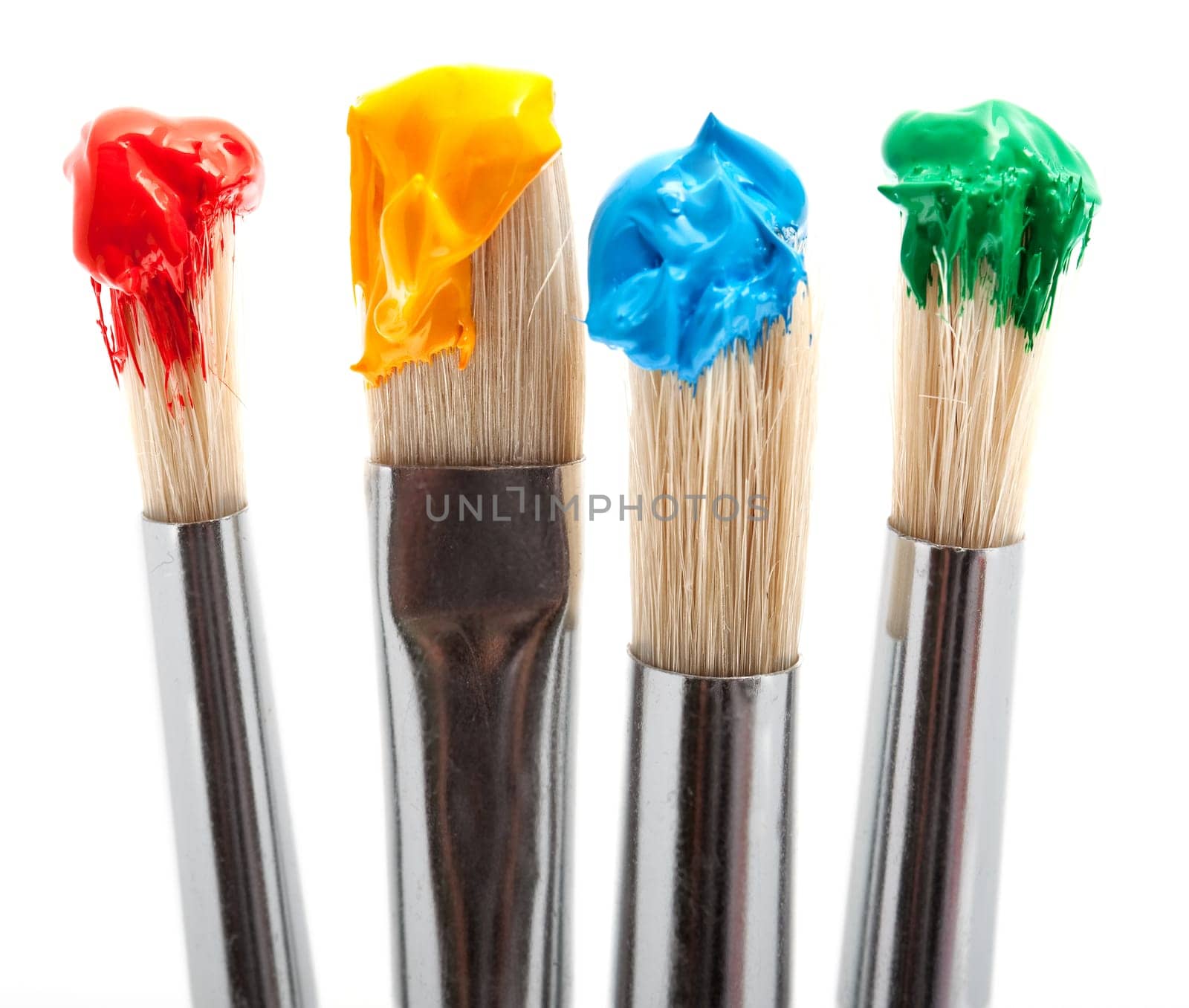 four brushes with paint