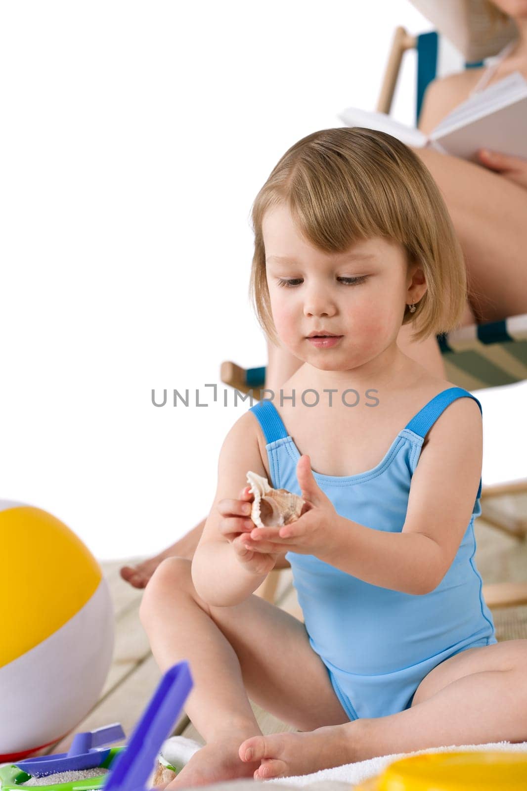 Beach - Mother with child playing with toys in sand