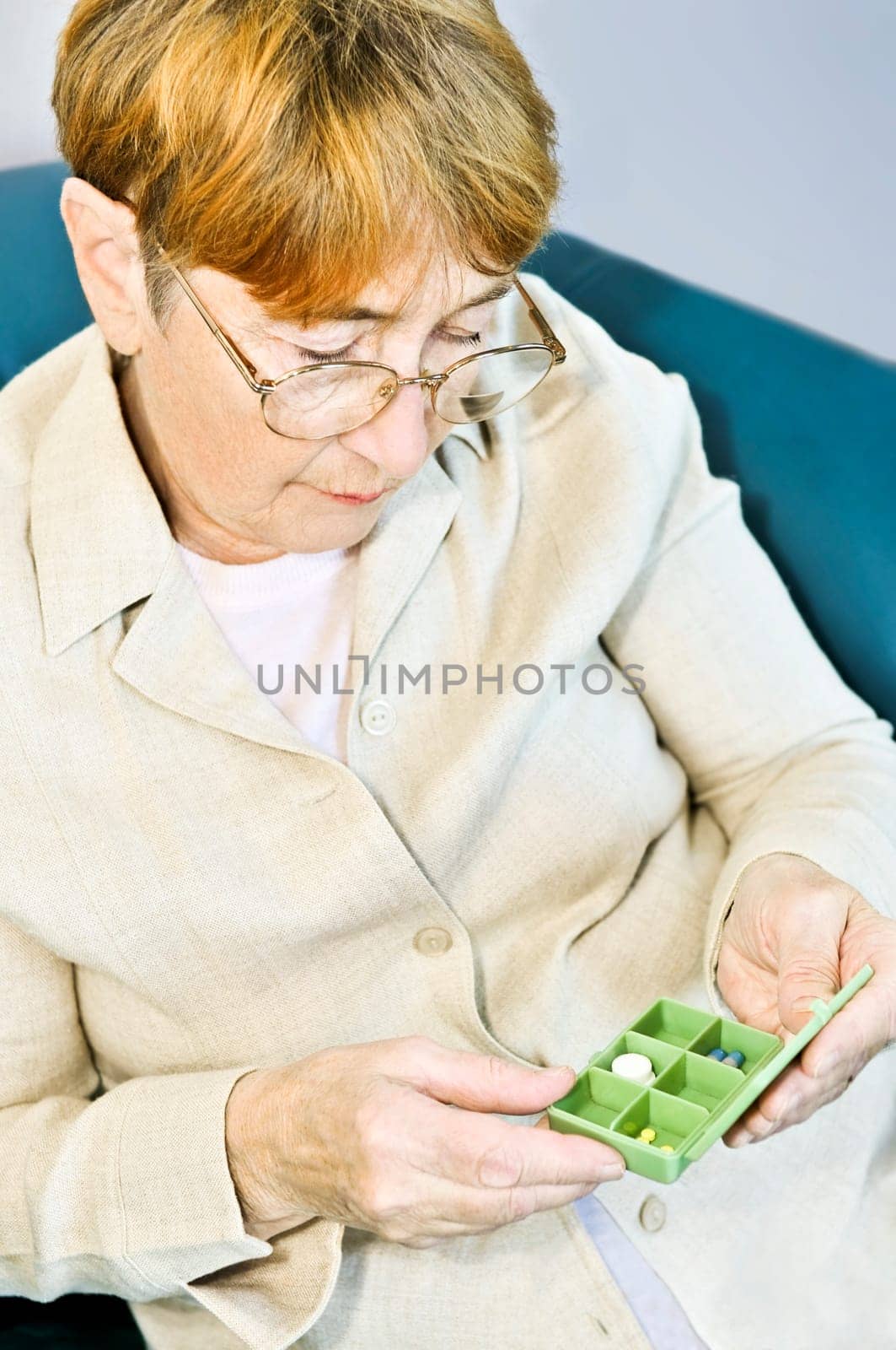 Elderly woman with pill box
