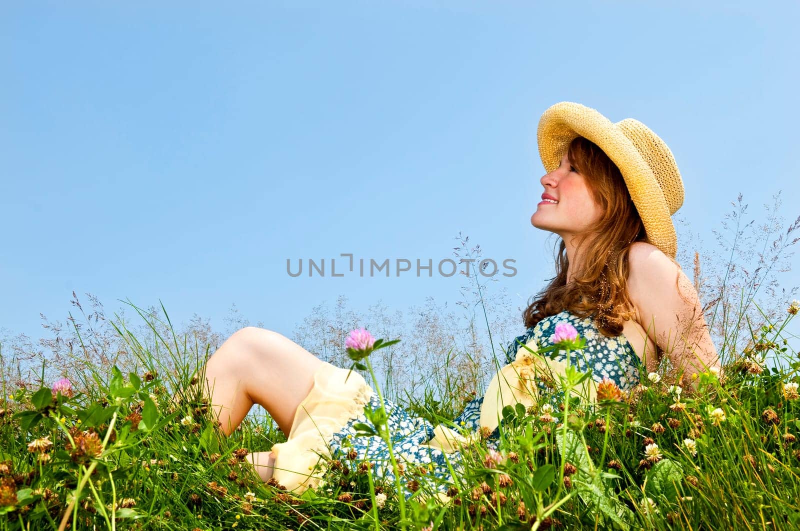 Young girl sitting in meadow
