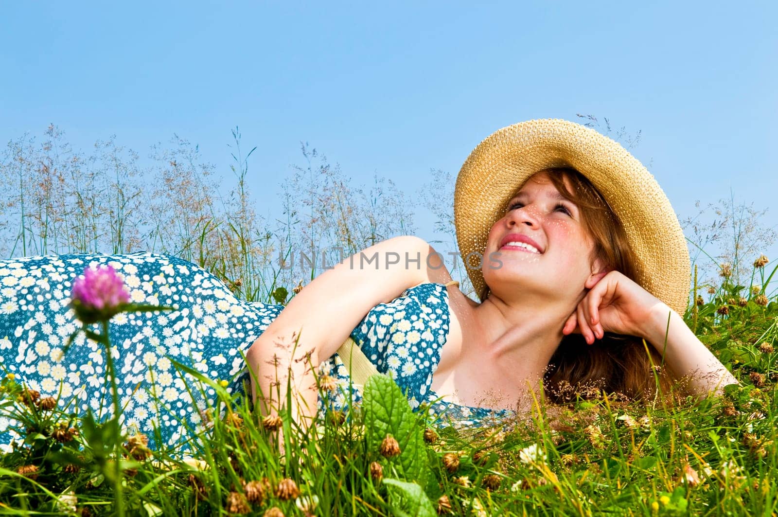 Young girl laying in meadow