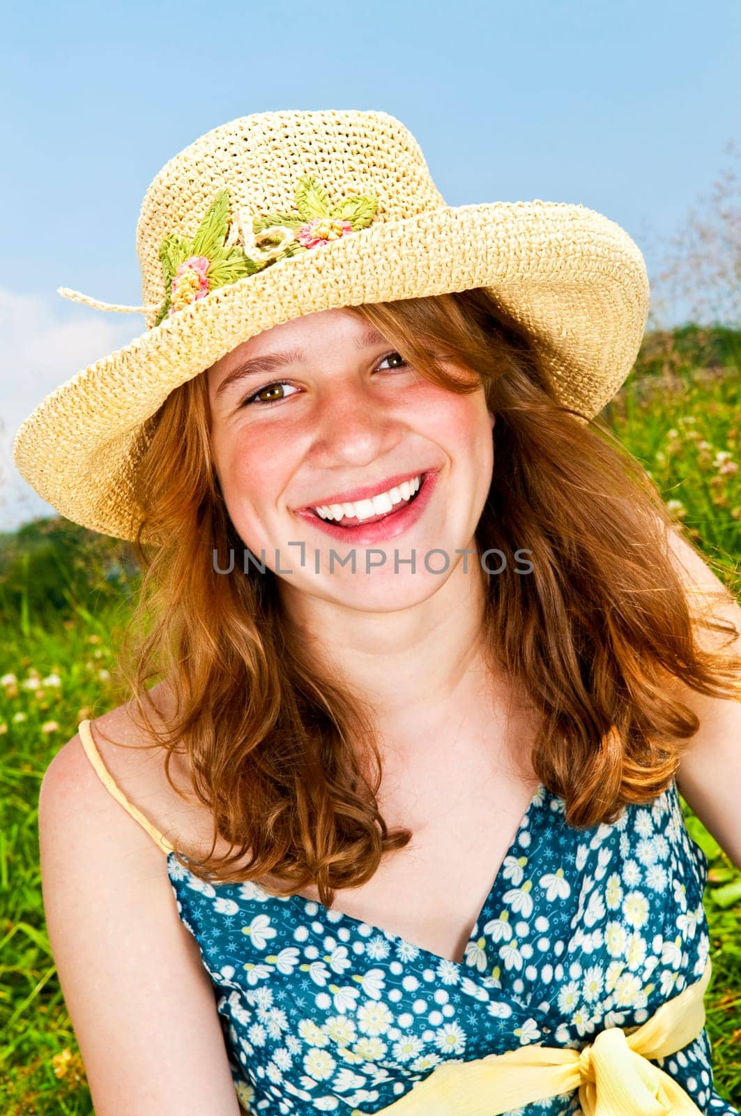 Portrait of young girl smiling in meadow