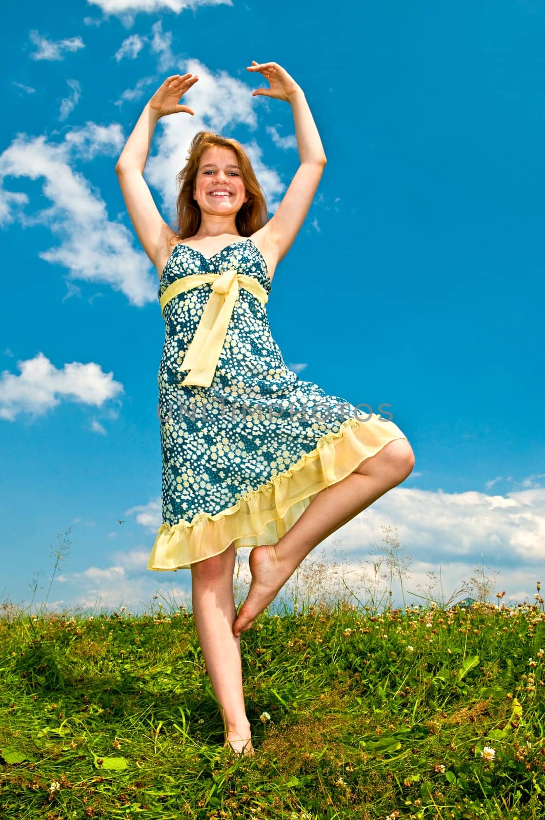Young girl dancing in meadow