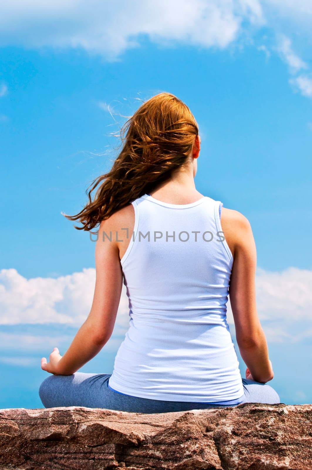 Young girl meditating outdoors
