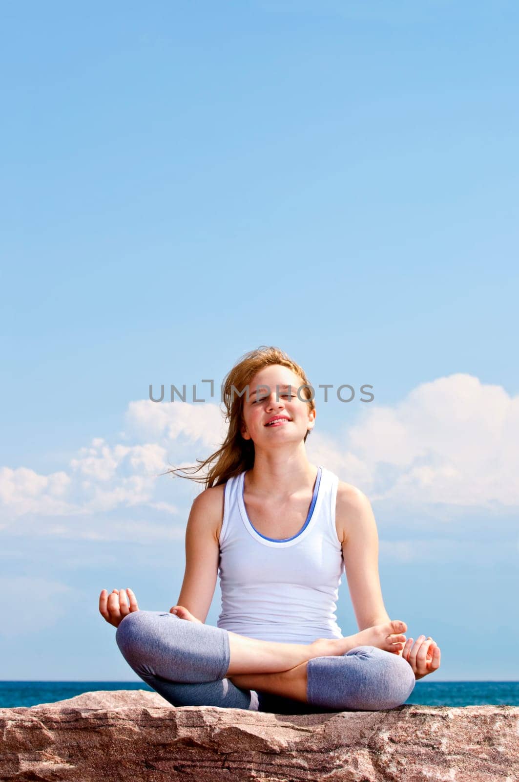 Young girl meditating outdoors