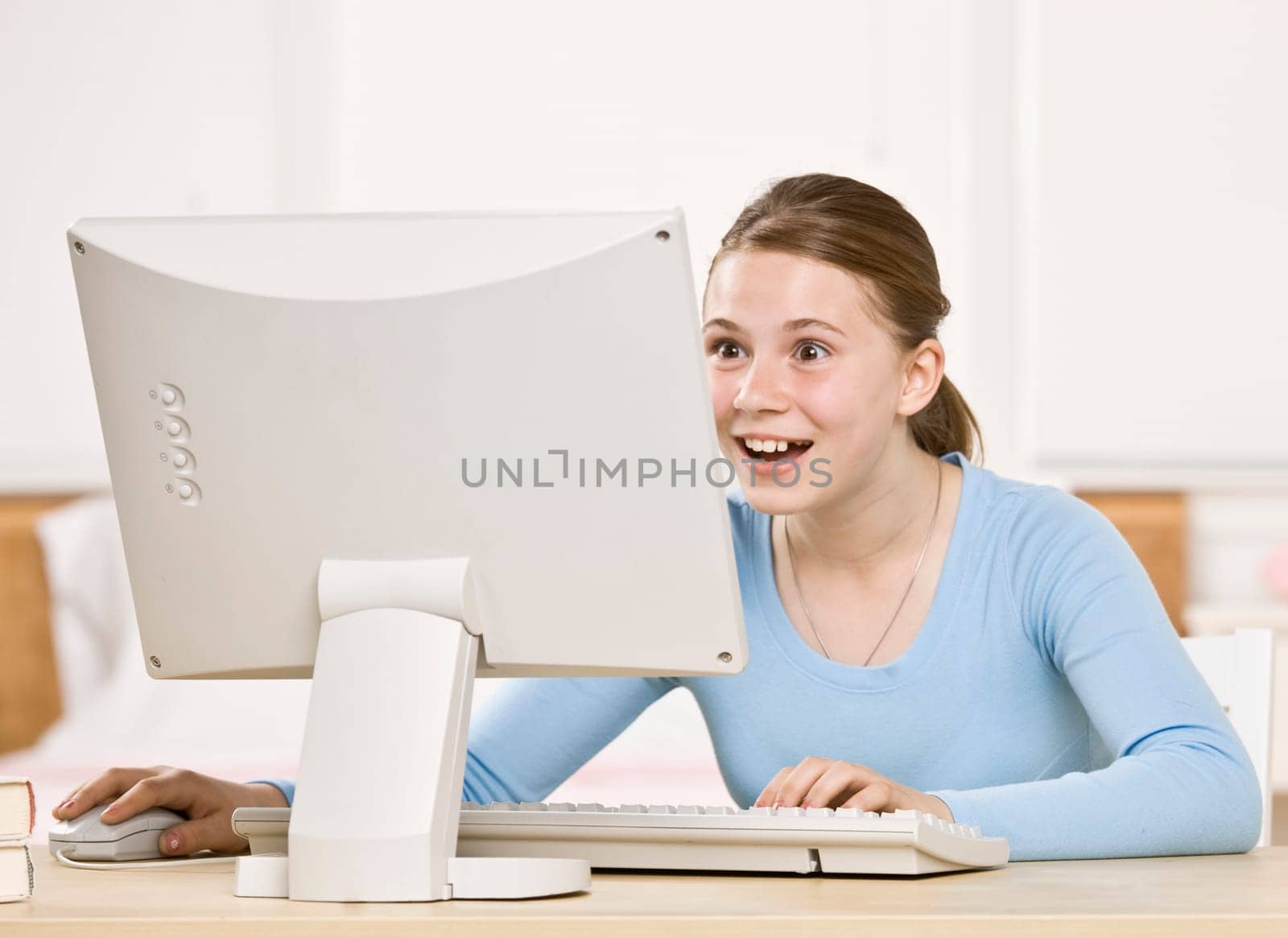 Young girl on computer. Horizontally framed shot.