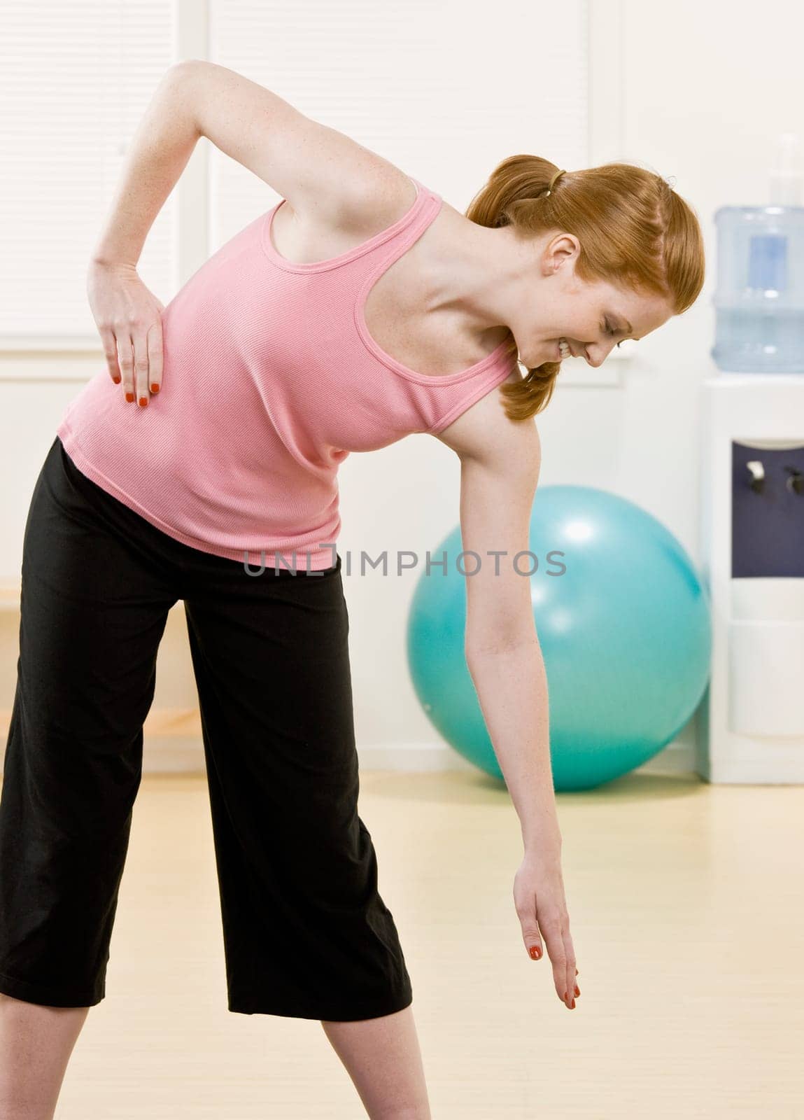 Young woman stretching. Vertically framed shot.