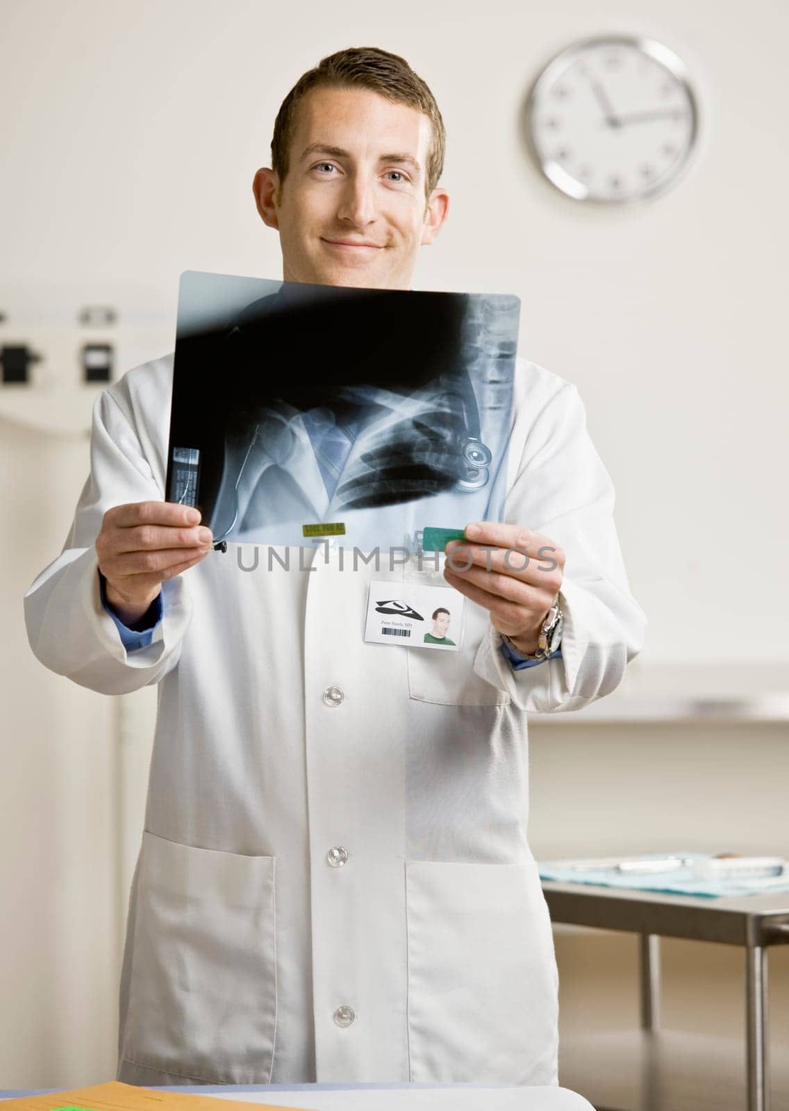 Young male doctor with x-ray. Vertically framed shot.