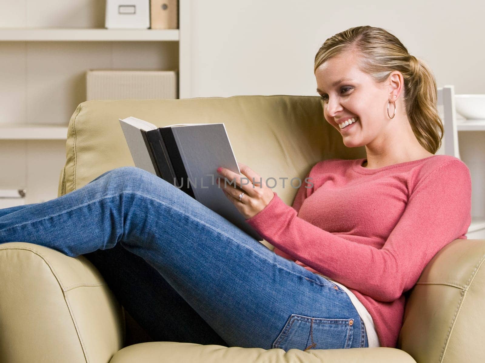 Teenage girl reading book in chair