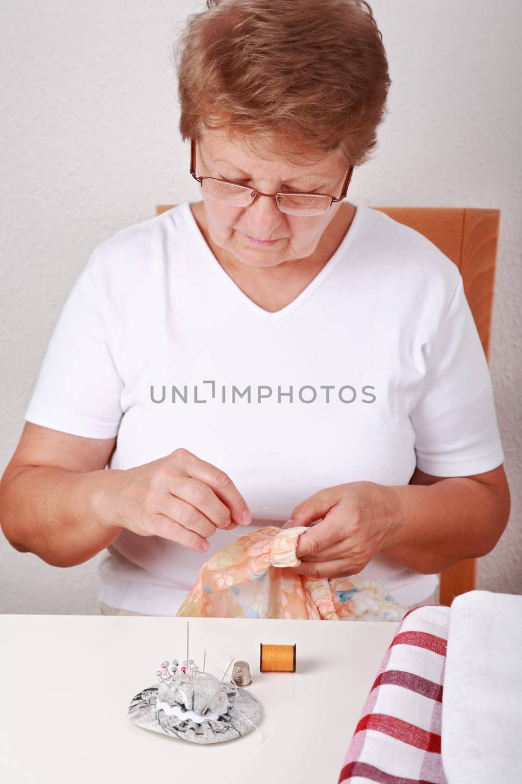 Elderly woman sewing